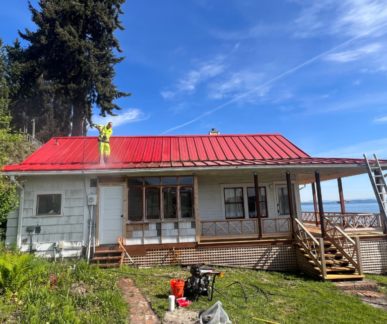 Before: cottage with red metal roof during prep