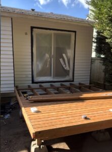 Craftsmen at work during the construction of a solid and durable wooden deck.