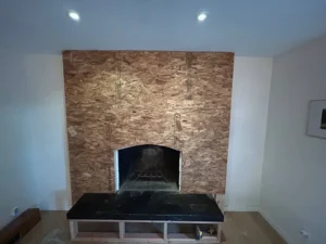 Custom fireplace installation in progress — structural framing and insert placement