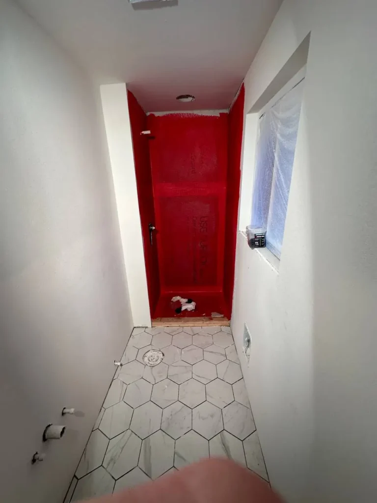 After: finished hexagon porcelain tile bathroom floor