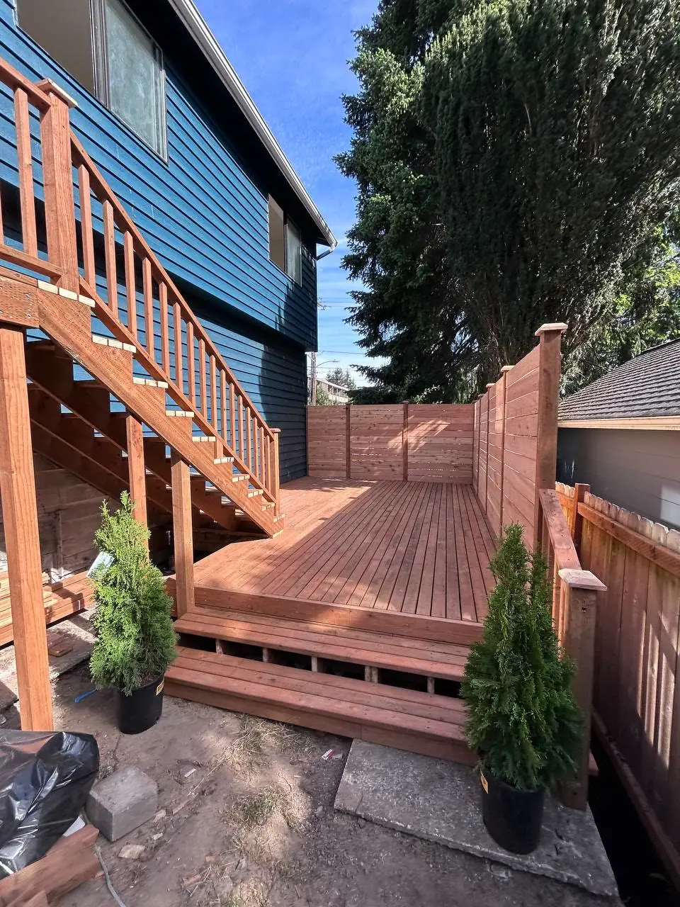 After: finished cedar deck with stairs and privacy fence