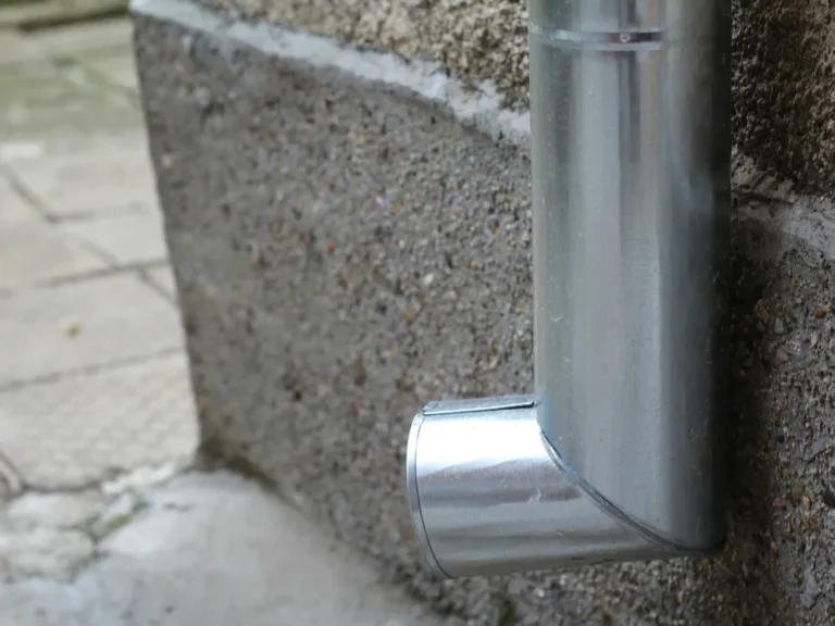 Downspout elbow on the side of a house