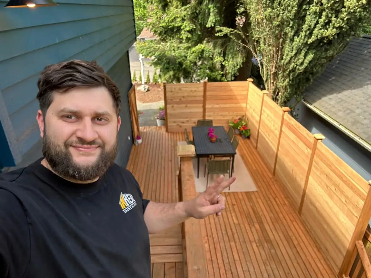 Inreal Construction owner on a finished cedar deck with privacy fence in Seattle