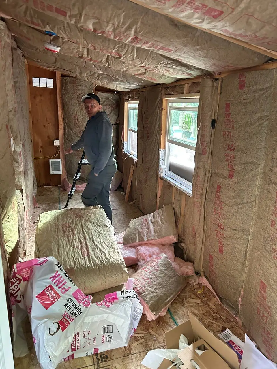 Unfinished room with exposed studs and insulation