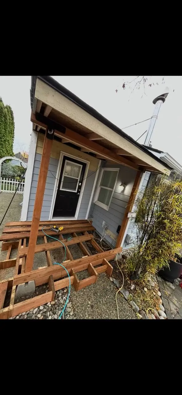 Framing stage: porch roof posts, beam and deck joists